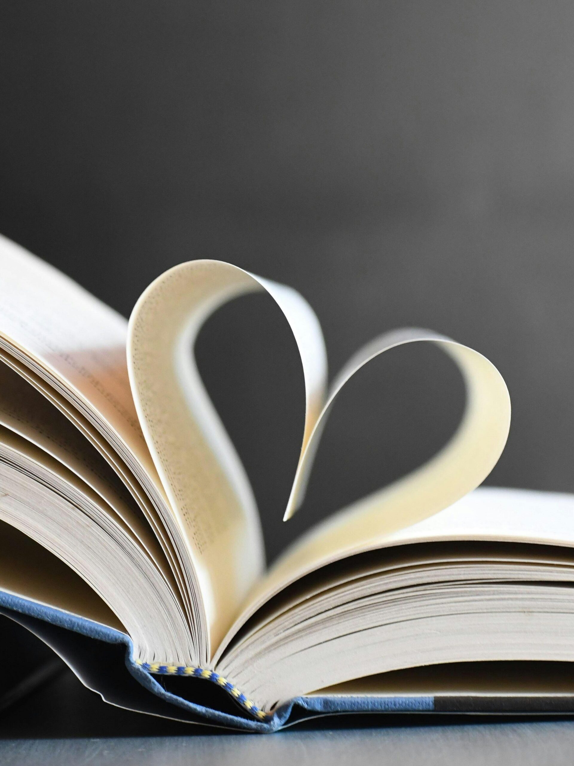 Open book with pages forming a heart, symbolizing love for reading and literature.